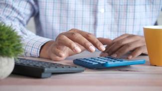 Man working on calculator