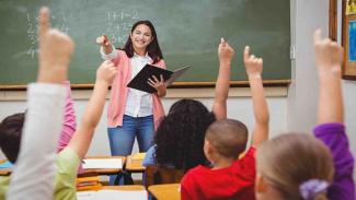 A teacher in their classroom.