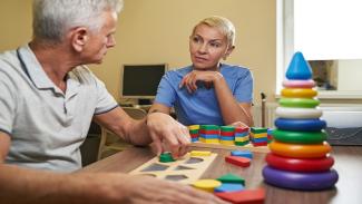 An Occupational Therapist with a patient.