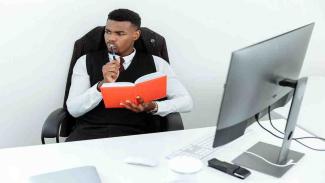 student doing research on what scholarships include on laptop