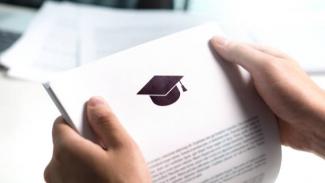 A student holding a copy of their bursary application motivation letter
