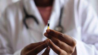 A nurse holding a needle injection