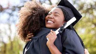 Two NRF funded graduates hugging