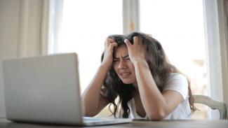 Student annoyed in front of laptop